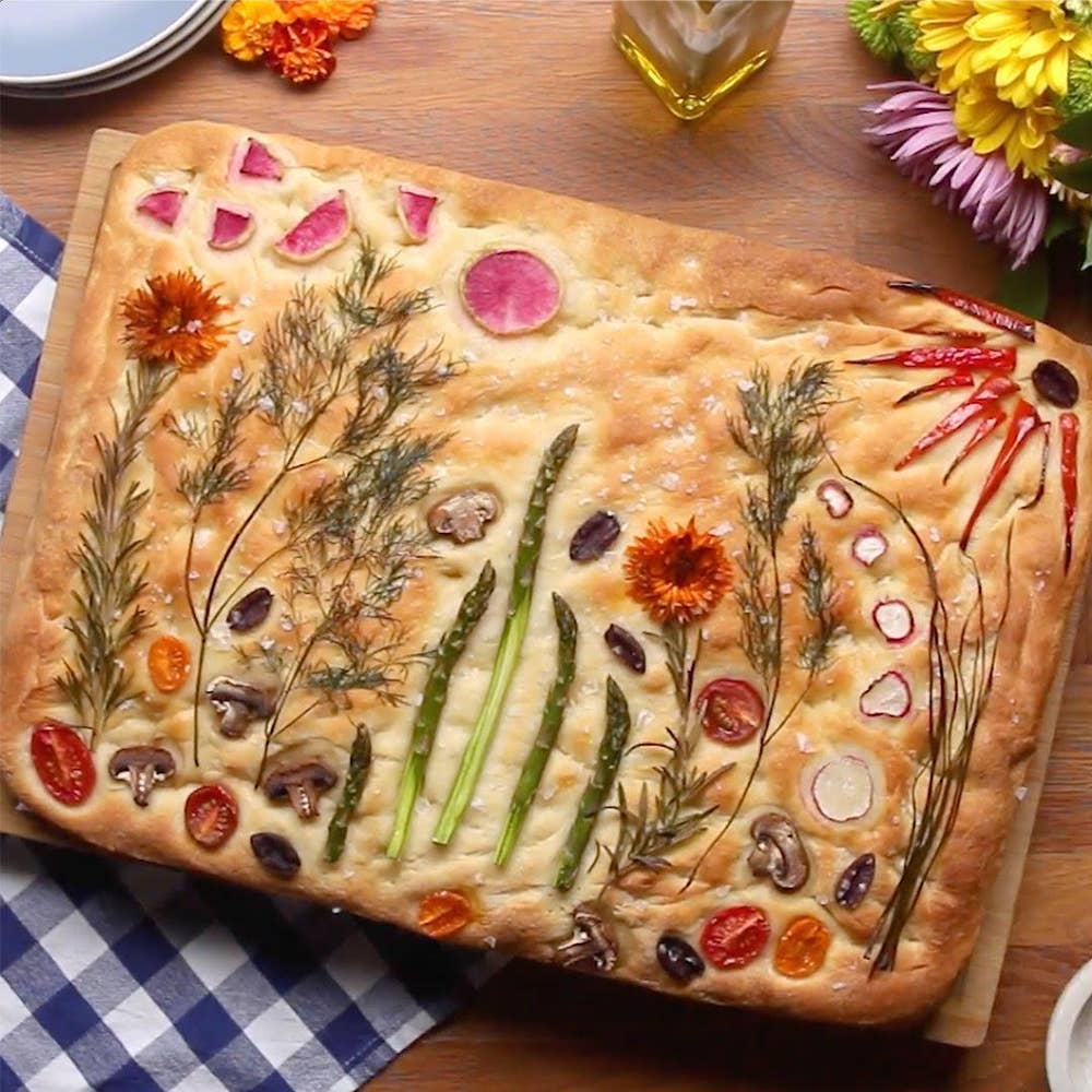 cooked pastry with herbs and plants in crust decorated into a spring garden scene