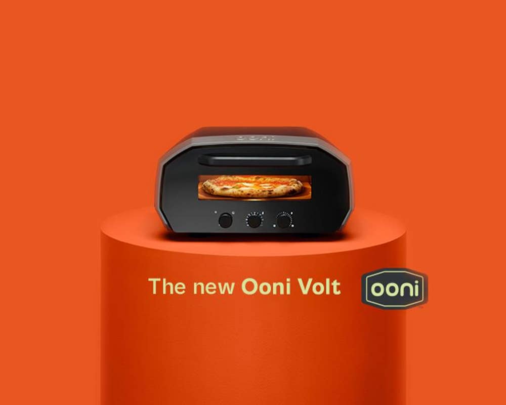 an Ooni volt pizza oven sits on a table under text