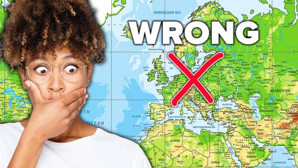An African American woman is reacting to a map projection of the world that has red "X" saying it's wrong. 