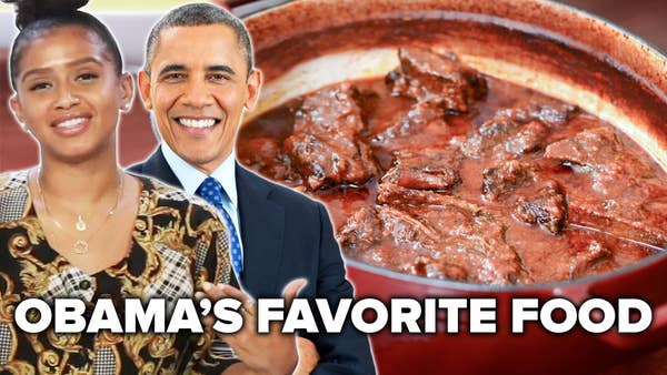 Woman stands next to picture of President Obama and plate of short ribs.