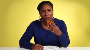 Mother eats piece of cornbread with confused face.