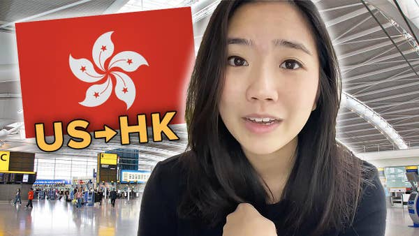 Helen with a Hong Kong flag, in front of airport photo.
