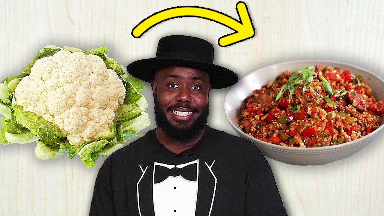 Chef Seth in between a cauliflower and a prepared dish.