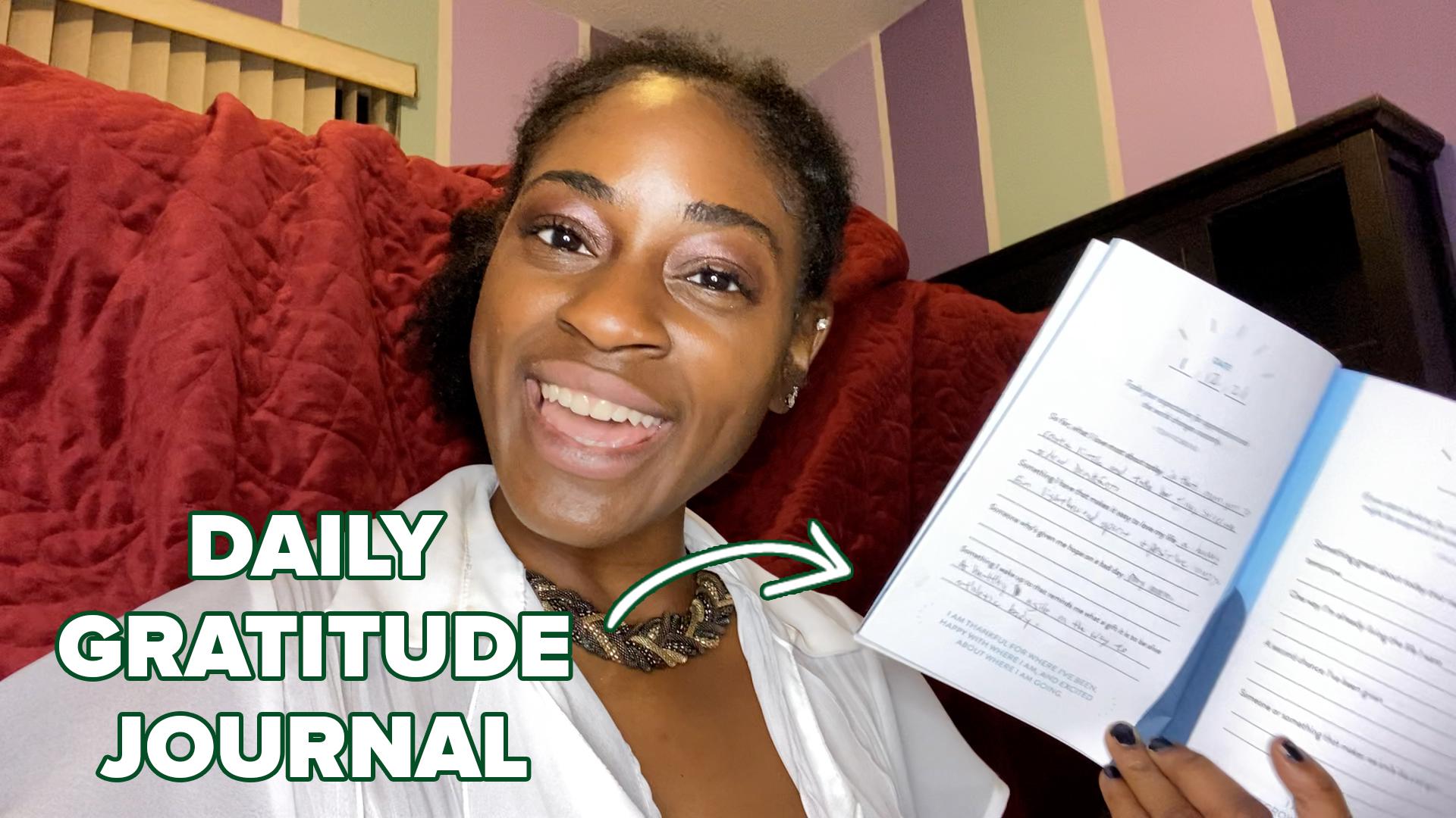 Vivian holding her gratitude journal.