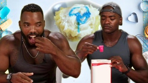 Two body builders and a tiny cake.