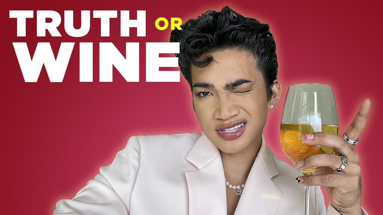 Bretman Rock with a glass of wine.