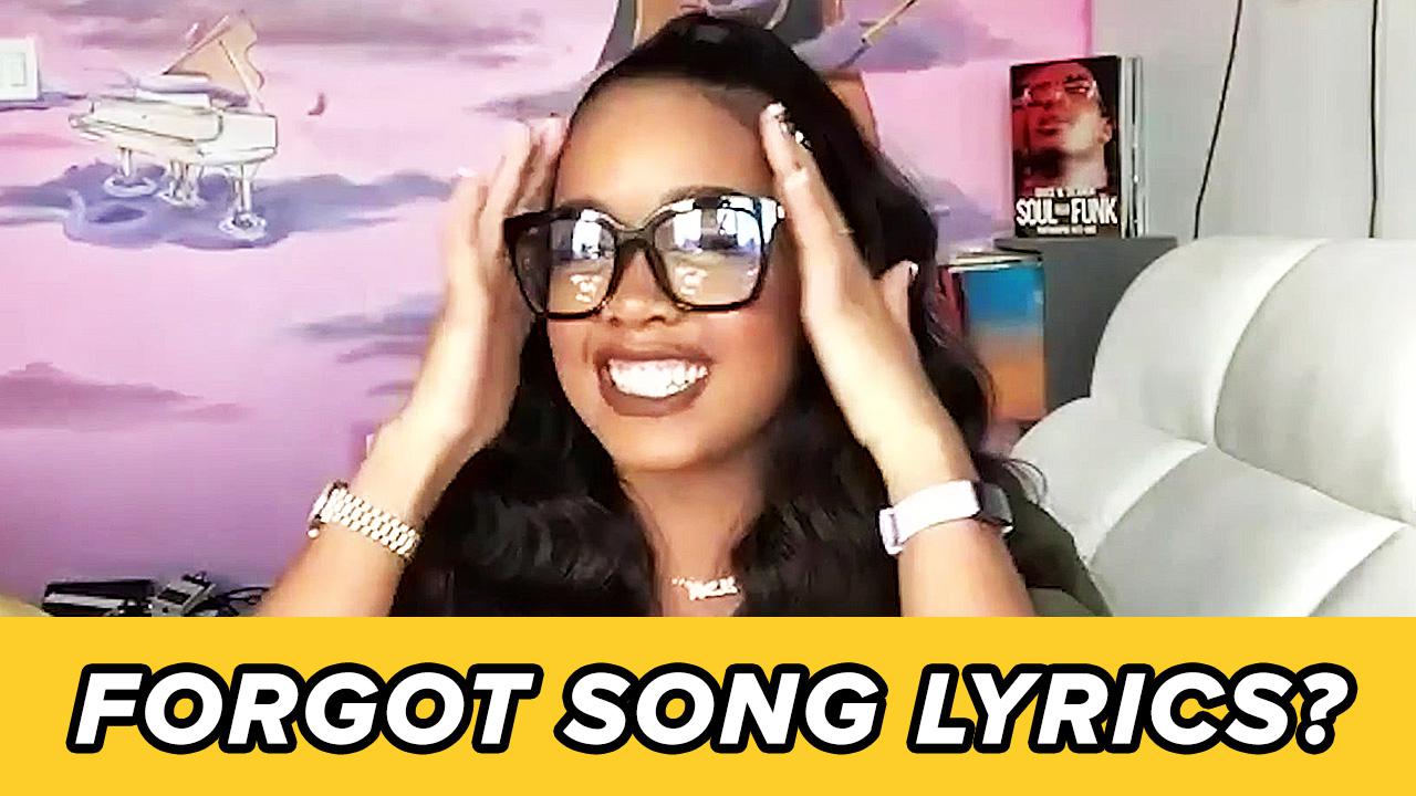 H.E.R. holds her head while answering questions