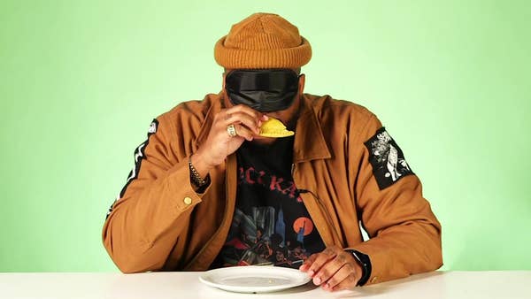 Michael Harvey takes a bite of a beef patty while blindfolded.