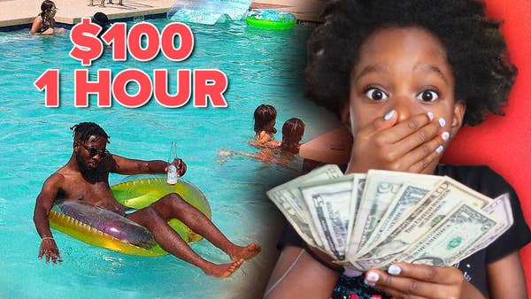 Lynnn holding $100 next to her father Andrew in swimming pool.
