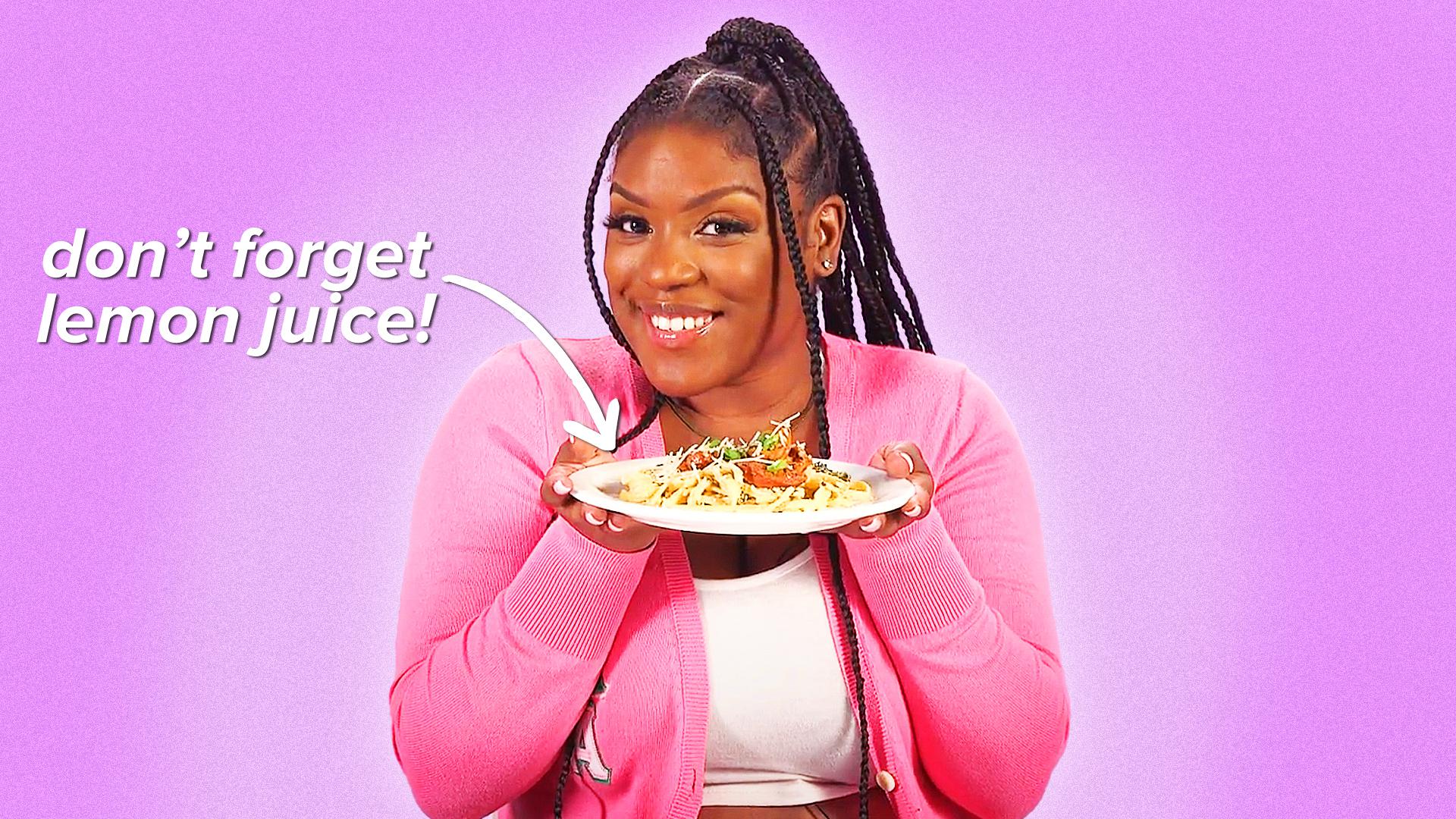Woman holding a plate of pasta.