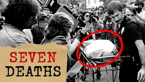 Black and white photo of crowd looking as police move a bodybag on a stretcher towards the camera. Text in bottom left corner reads, "SEVEN DEATHS."