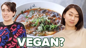 Merle and Rie with a questionable face in front of a bowl of vegan ramen.