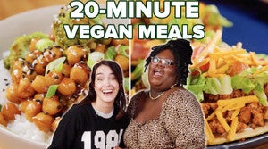 Merle and Joyce smiling in front of a vegan dish.