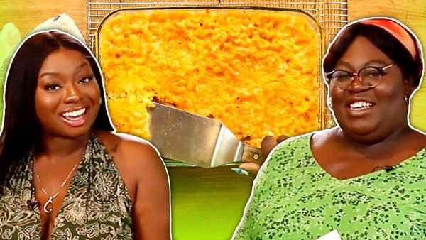Tati (left) and Joyce (right) smile. A dish with the finished baked mac and cheese with a spatula scooped in separates the two.