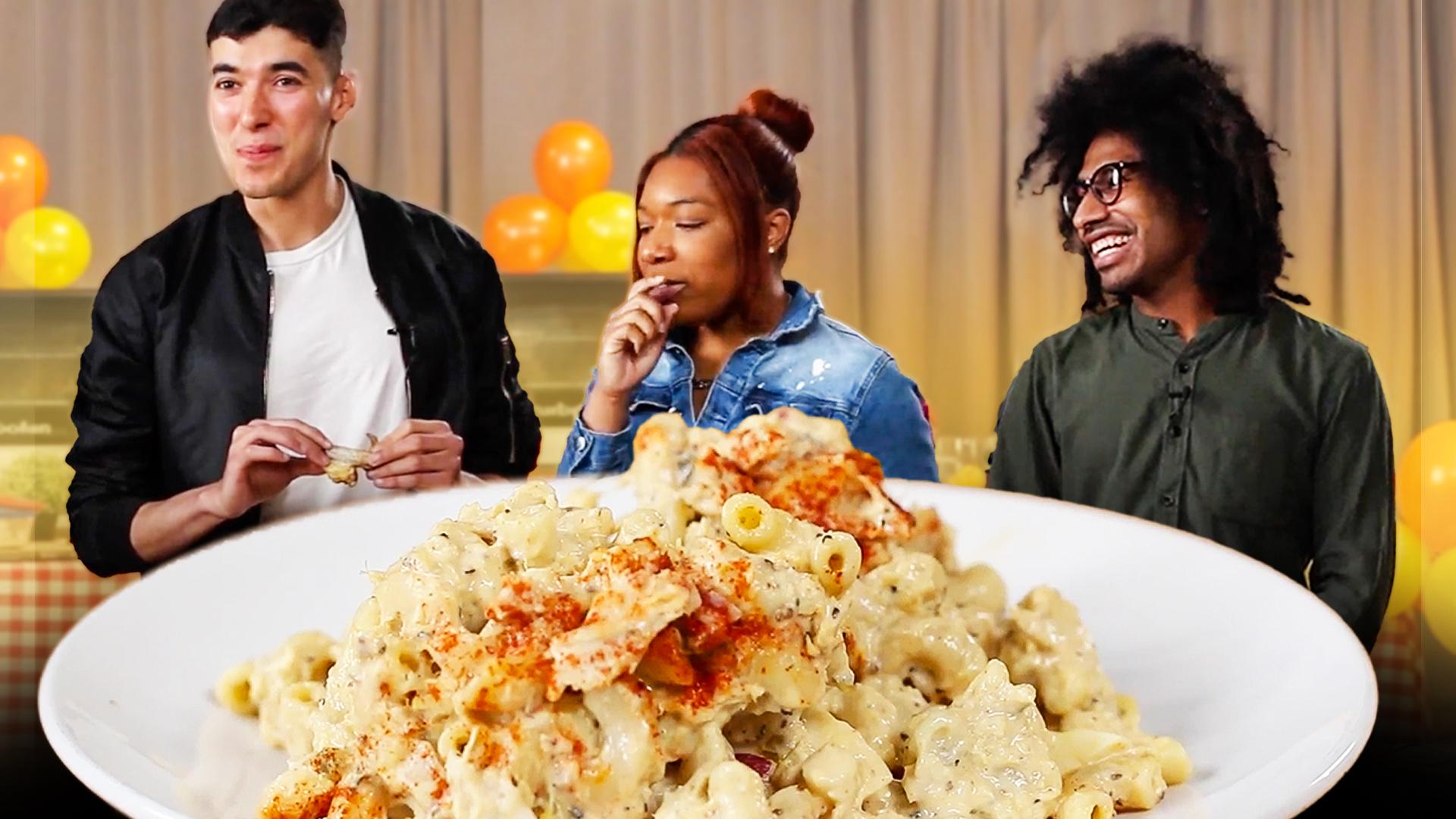 A "plus one" (left) and two "family members" stand in front of a plate of one of the participant's mac n cheese that they just tasted.