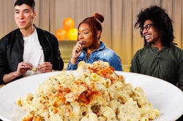 A "plus one" (left) and two "family members" stand in front of a plate of one of the participant's mac n cheese that they just tasted. 