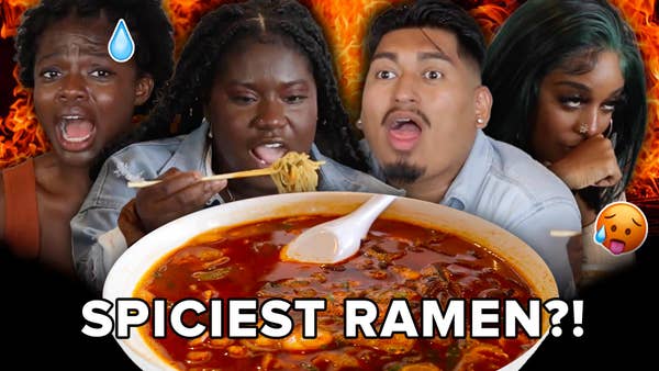 Selorm makes a hot/sweat face emoji. Élise takes a bite of ramen with chopsticks. Alex is gasping for air. Jaidyn holds back vomit. A bowl of the spicy ramen they tried is inflated to appear in the bottom center of the frame. 