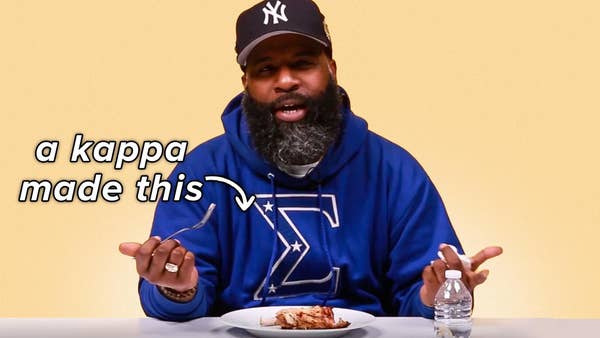 A man representing the Sigmas looks questionably at a plate of grilled chicken. A text bubble, reading "a kappa made this" hovers over the food.