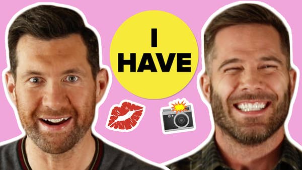 Left: Billy Eichner with a shocked expression on his face; Right: Luke Macfarlane laughing; There is an "I have" sign in the background with a kiss and camera emojis
