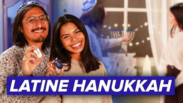 Stephen and Vanessa holding dreidels smiling at the camera with text reading "Latine Hanukkah" across the screen.  