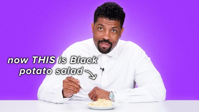 Deon Cole pokes at potato salad with his fork in a white shirt. Text reads, 