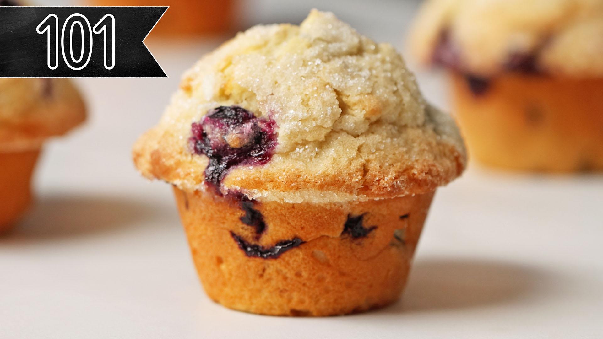 A perfect, bakery style blueberry muffin sits atop a counter. "101," can be read in the top left corner.