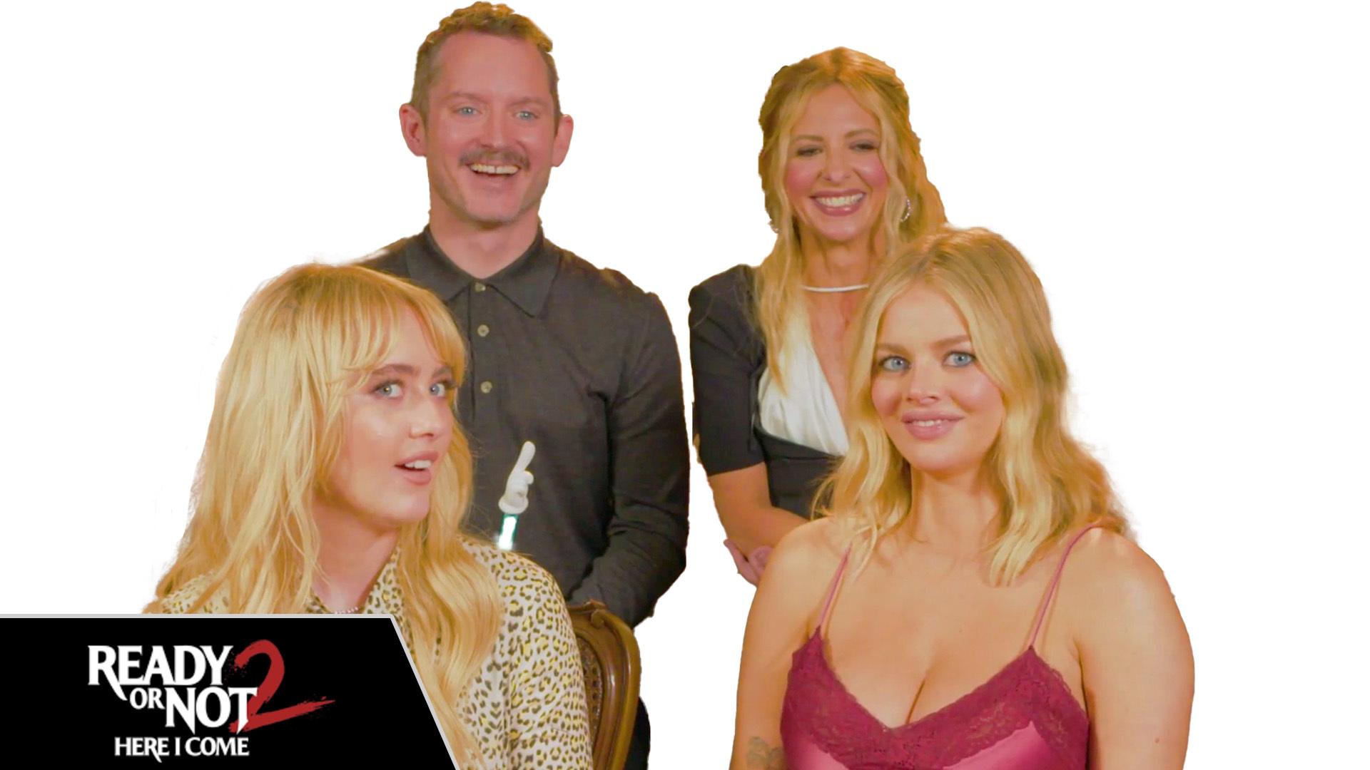 The cast of "Ready or Not 2: Here I Come" are seen in front of a white background with the the text of the film's name seen on the bottom left. 